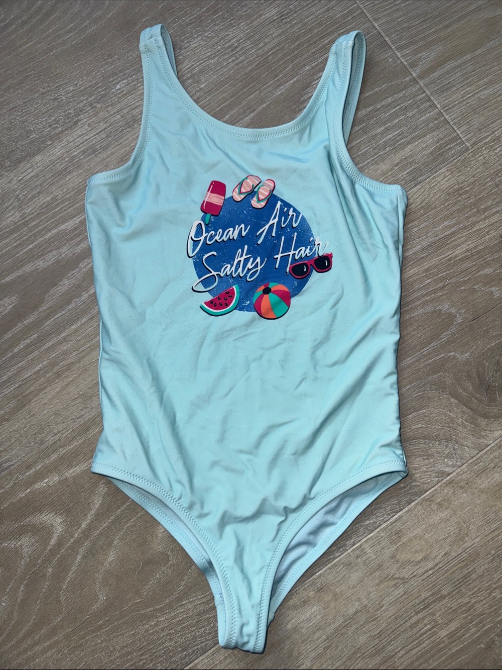 Light Blue One-Piece Swimsuit with 'Ocean Air Salty Hair' Graphic